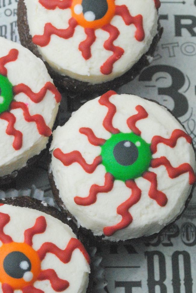 close up of four chocolate cupcakes with bloody eyeballs 
