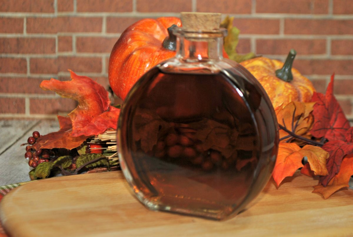 Corked pumpkin spiced bourbon with fall decor
